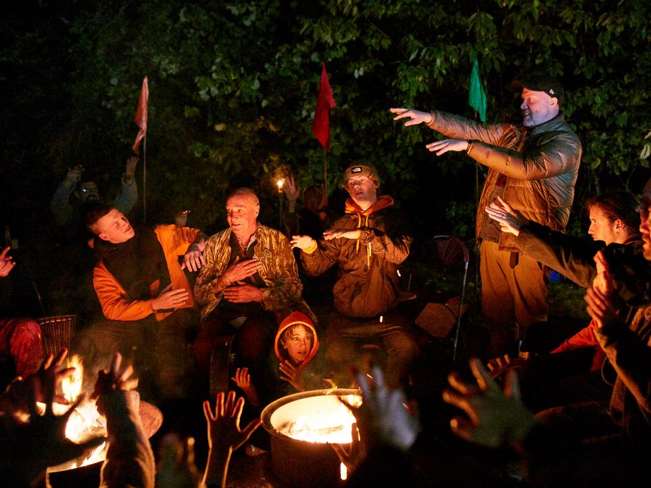 Boys and mentors around the fire at a Rites of Passage weekend